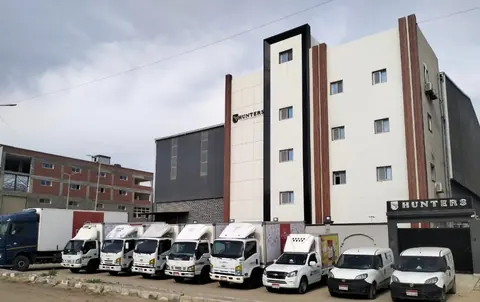 The Hunters head office building in Gamasa with delivery vans parked in front